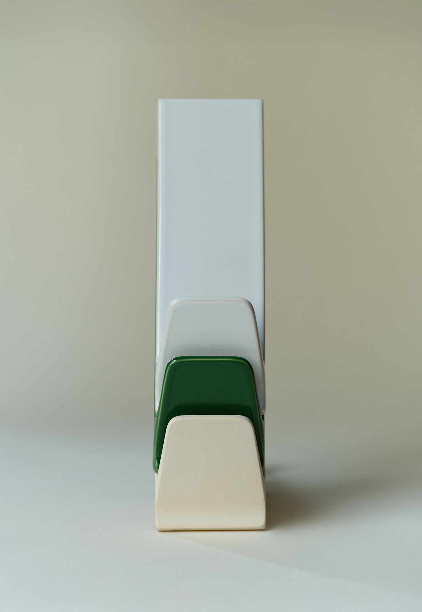 A pile of three ceramic hangers.